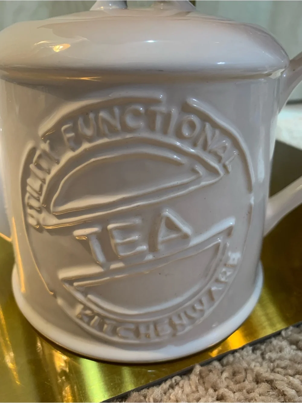 White Ceramic Teapot with Embossed 'Tea' Motif